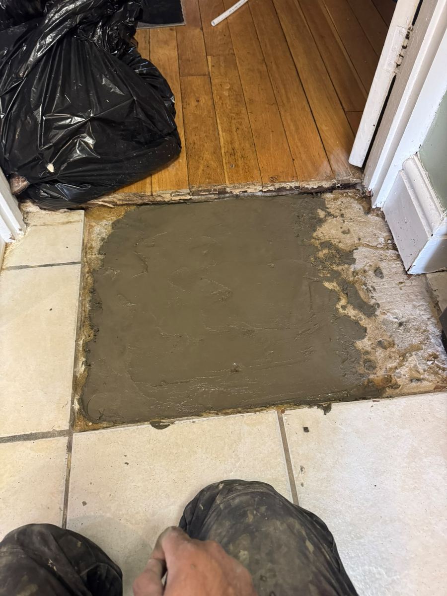 Floor opening filled with mortar after the leak repair